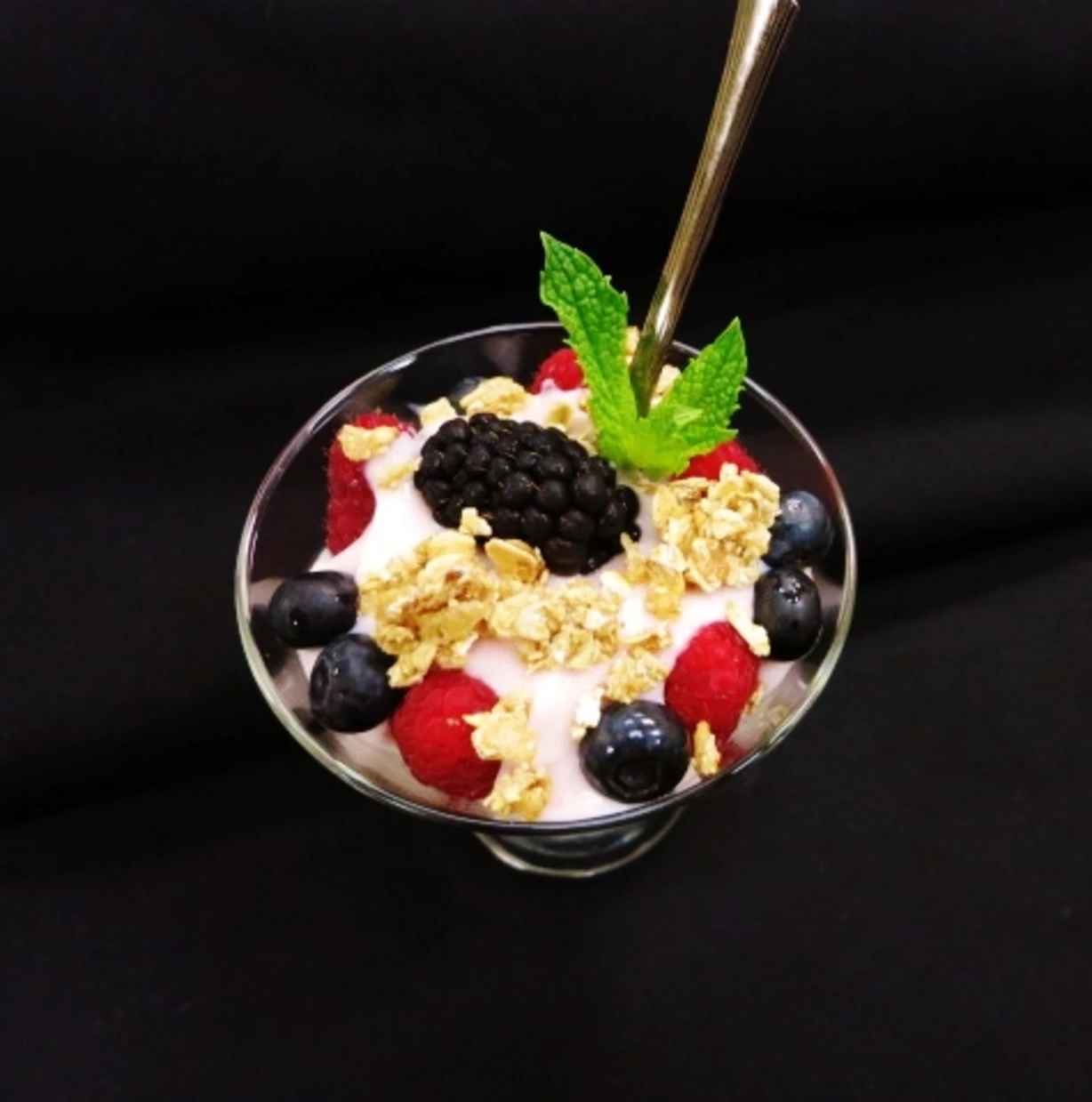 Yogurt parfait with berries and granola in a glass