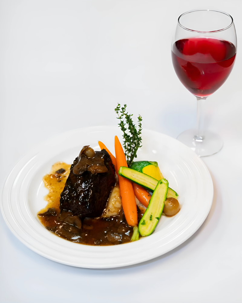Plated braised short rib with vegetables and red wine