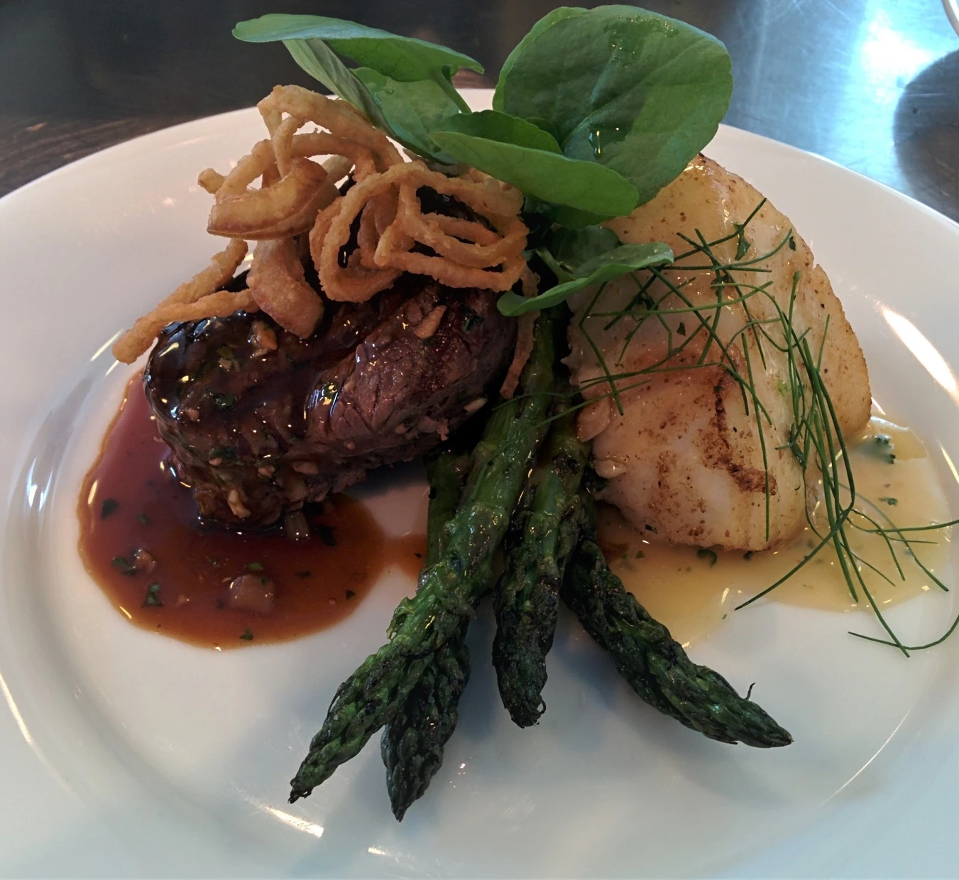 Filet mignon and seared scallop with asparagus and crispy onions
