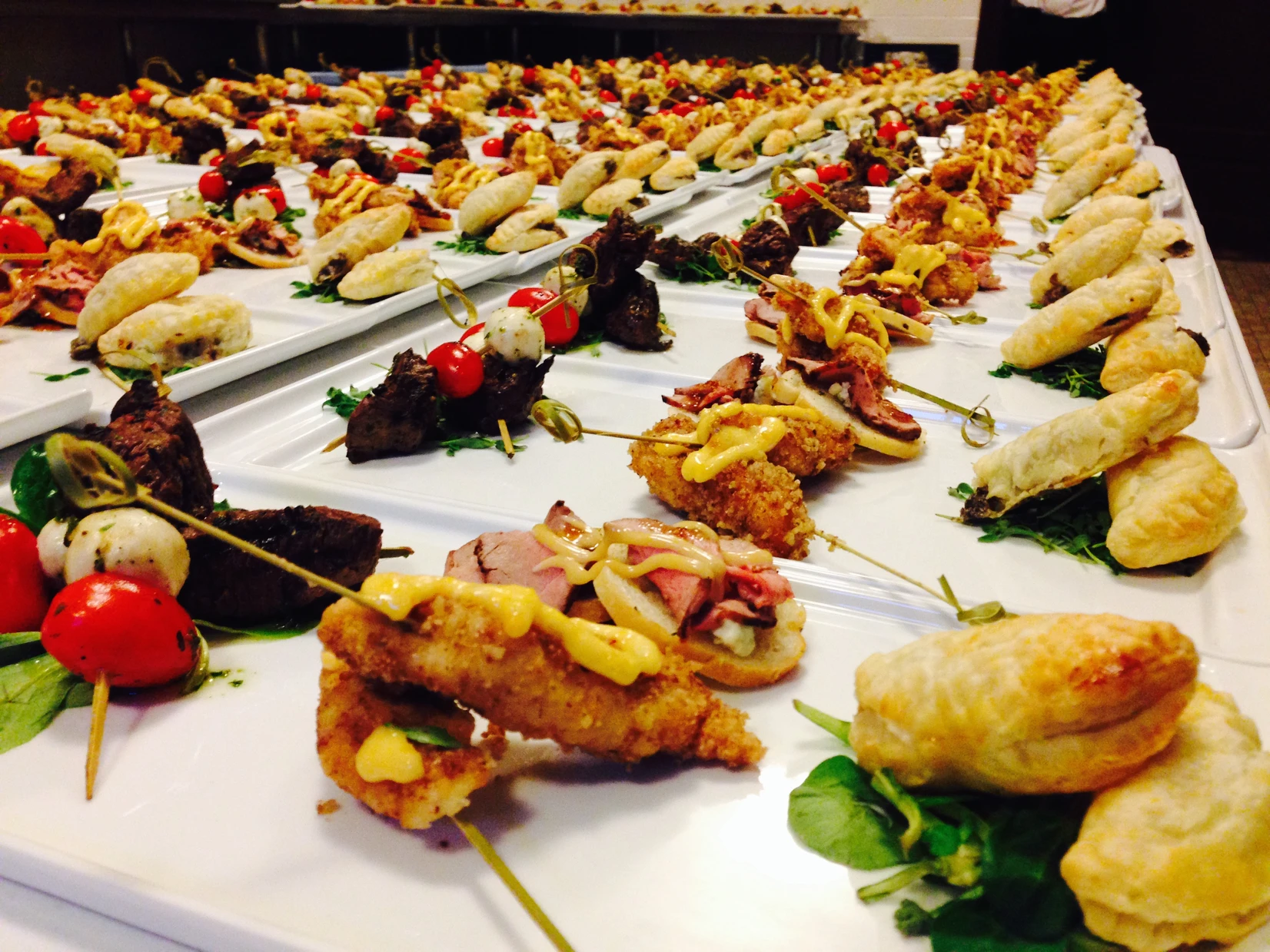 Trays of passed hors d'oeuvres prepared for a corporate reception